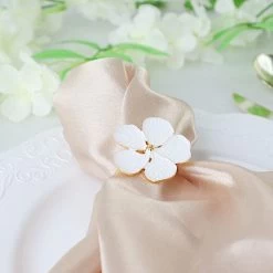 4 Gold Metallic Napkin Rings With White Flower Design